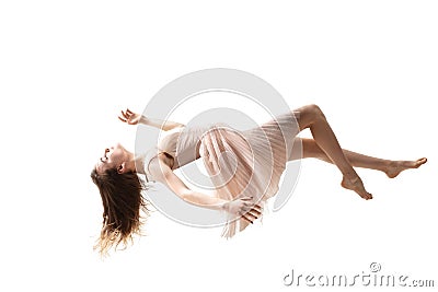 Mid-air beauty. Full length studio shot of attractive young woman hovering in air and keeping eyes closed Stock Photo