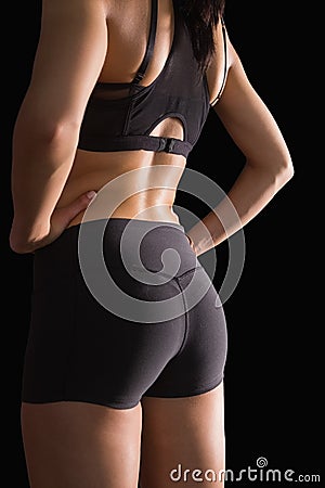 Mid section of the backside of young slim woman wearing sportswear Stock Photo