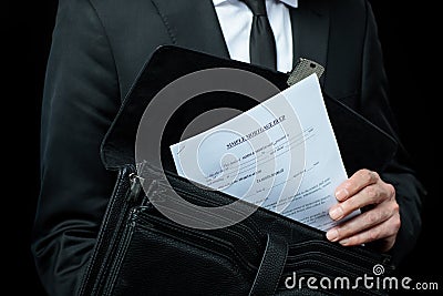 Mid section of businessman in suit holding briefcase with papers Stock Photo