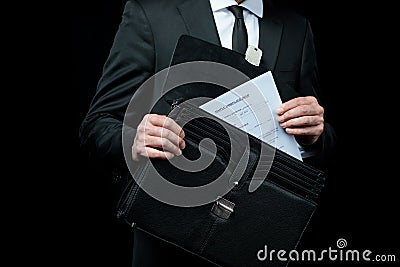 Mid section of businessman in suit holding briefcase with papers Stock Photo