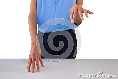 Mid section of businesswoman holding something at table Stock Photo