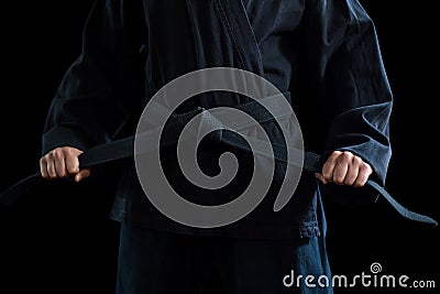 Mid section of confident karate player holding his belt Stock Photo