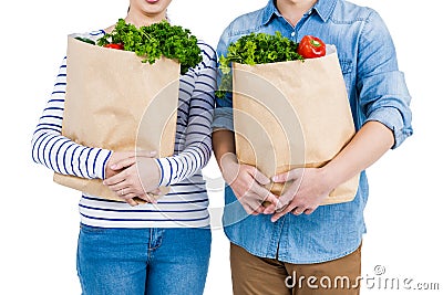 Mid section of couple holding grocery bags Stock Photo