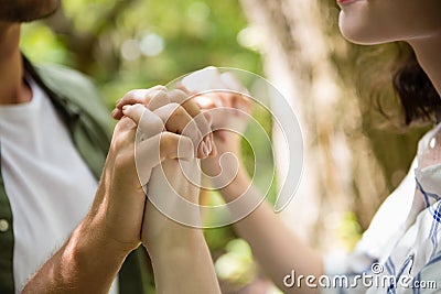 Mid-section of couple holding hands Stock Photo