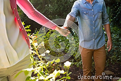 Mid-section of couple holding hands Stock Photo