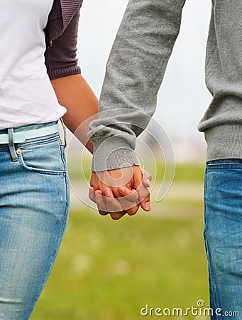 Mid section image of a couple holding hands Stock Photo