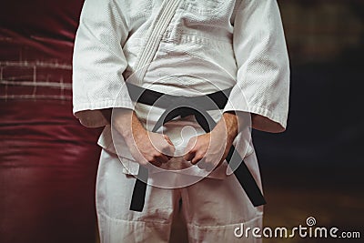 Mid section of karate player making fist Stock Photo