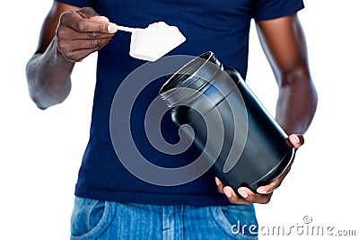Mid section of man holding a scoop of protein mix Stock Photo