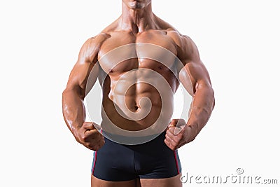 Mid section of a muscular young man clenching fists Stock Photo