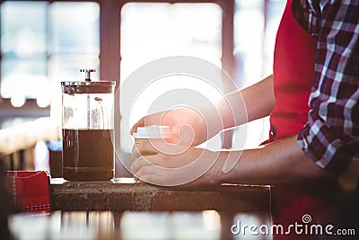 Mid section of waiter preparing coffee Stock Photo