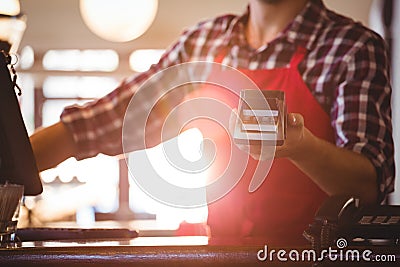 Mid section of waiter showing credit card machine Stock Photo