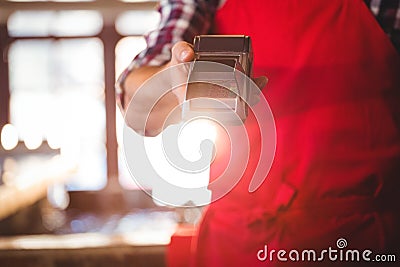 Mid section of waiter showing credit card machine Stock Photo