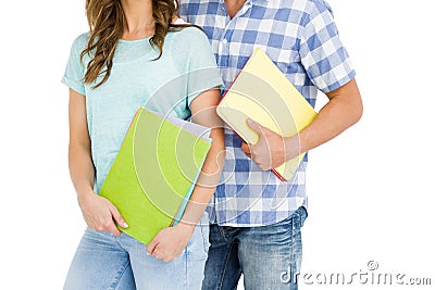 Mid section of young couple holding book and folder Stock Photo