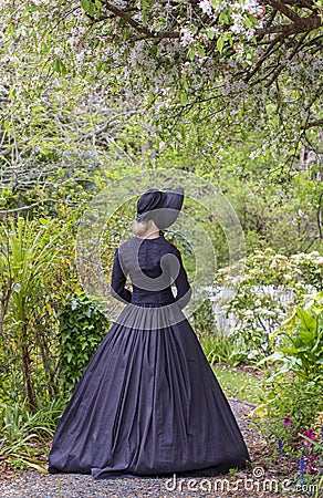 Victorian woman in summer garden Stock Photo