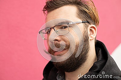Middle adult man funny smiling face portrait with beard and mustache with vivid pink and white painted wall background Stock Photo