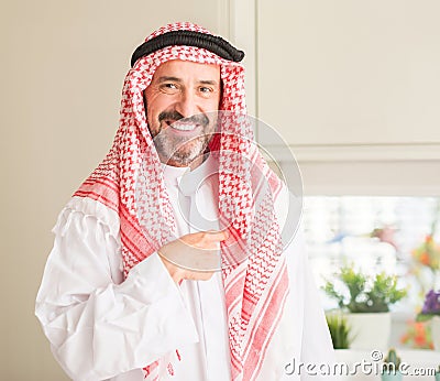 Handsome senior man with hijab at home Stock Photo