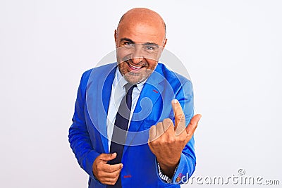 Middle age businessman wearing suit standing over isolated white background Beckoning come here gesture with hand inviting Stock Photo