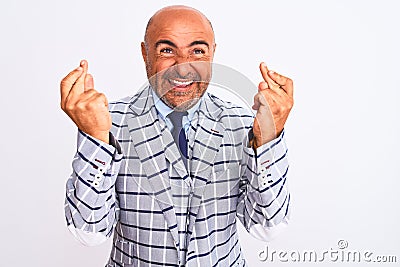 Middle age businessman wearing suit standing over isolated white background gesturing finger crossed smiling with hope and eyes Stock Photo
