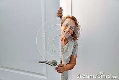 Middle age caucasian woman smiling happy getting in new home Stock Photo