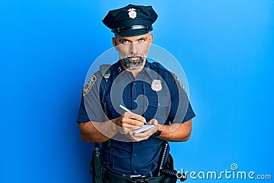 Middle age handsome man wearing police uniform writing traffic fine skeptic and nervous, frowning upset because of problem Stock Photo