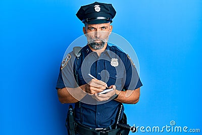 Middle age handsome man wearing police uniform writing traffic fine skeptic and nervous, frowning upset because of problem Stock Photo