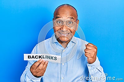Middle age latin man holding paper with backlinks message screaming proud, celebrating victory and success very excited with Stock Photo