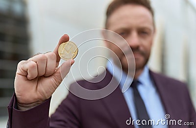 Middle age man business worker holding monero crypto currency at street Editorial Stock Photo