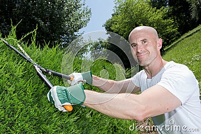 Middle-age man grass cutting in garden Stock Photo