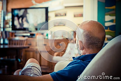 Middle age man watching tv Stock Photo