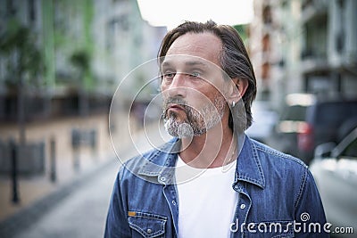 Middle age mature man experiencing hangover emotionally exhausted looking angry or frustrated. Middle age crisis man Stock Photo