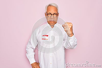 Middle age senior grey-haired man wearing hello my name is introduction sticker annoyed and frustrated shouting with anger, crazy Stock Photo