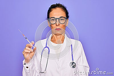 Middle age senior professional doctor woman holding syringe with medical vaccine with a confident expression on smart face Stock Photo