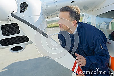 Middle-age service engineer working for preparation aircraft Stock Photo