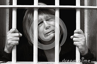 Middle Age Woman Behind Bars Stock Photo