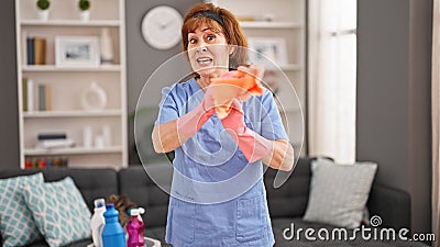 Middle age woman professional cleaner angry screaming home Stock Photo