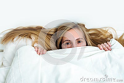 Middle age woman real portrait bed bedroom blonde long hair fifty plus copy space 50 blanket pillow face Stock Photo