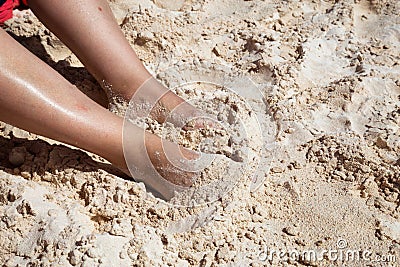 Middle Age Woman`s Feet inside White Sand Stock Photo