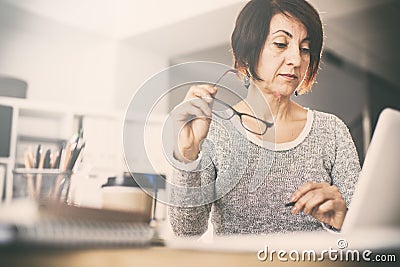 Middle age woman using computer Stock Photo