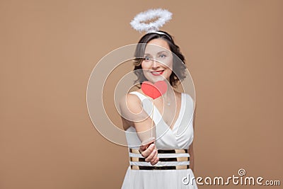 Middle aged angel brunette woman in white dress with nimbus on t Stock Photo