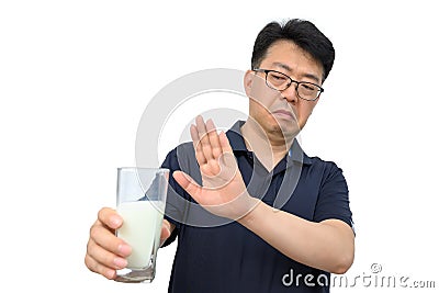 A middle-aged Asian male refusing milk Stock Photo