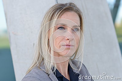 Middle-aged blond woman deep in thought Stock Photo