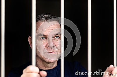 Middle aged blue eyed man incarcerated Stock Photo