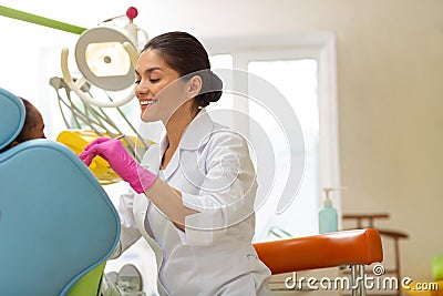 Middle-aged Caucasian female dentist performing a dental exam Stock Photo