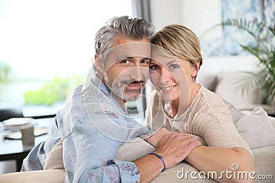 Middle-aged couple embracing at home Stock Photo