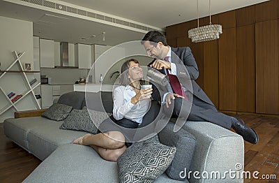 Middle aged couple in formalware in their city apartment with a Stock Photo