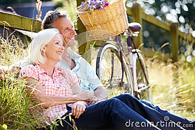 Middle Aged Couple Relaxing On Country Cycle Ride Stock Photo