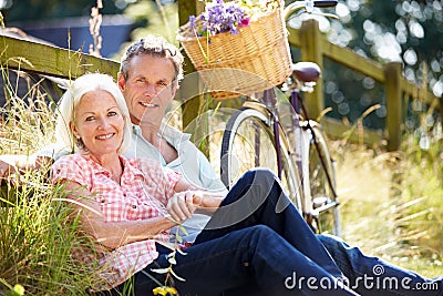 Middle Aged Couple Relaxing On Country Cycle Ride Stock Photo