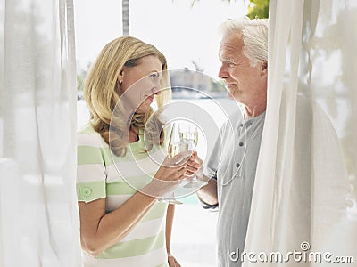 Middle Aged Couple Toasting Champagne Flutes Stock Photo