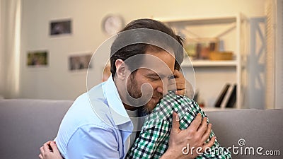 Middle-aged father hugging schoolboy son, family care and trustful relations Stock Photo