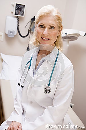 Middle Aged Female Doctor In Hospital Ward Stock Photo